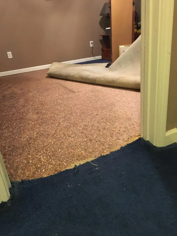 Carpet pad removal revealing water damage during Water Mitigation Services in Bogalusa